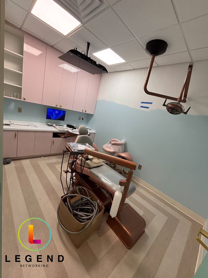 Dental operatory under construction at Smile Society Dental Studio in Jacksonville with clinical monitor and imaging arm installed.