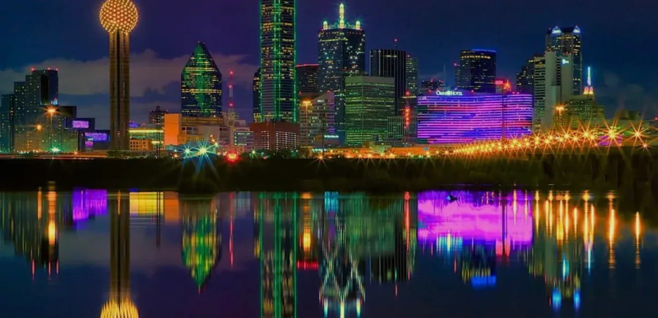 Vibrant nighttime view of the Downtown Dallas skyline and its reflection