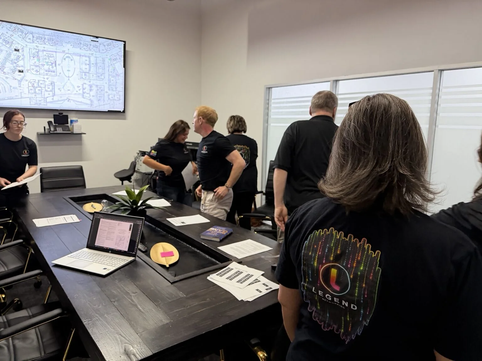 Legend Networking technicians collaborating around a table in the Dallas office