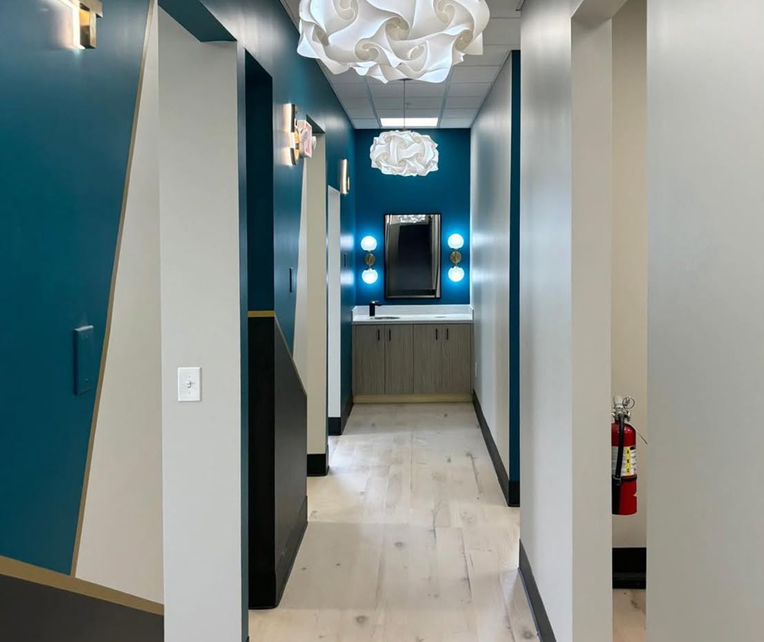 Practice corridor with teal doors at Calm Family Dental.