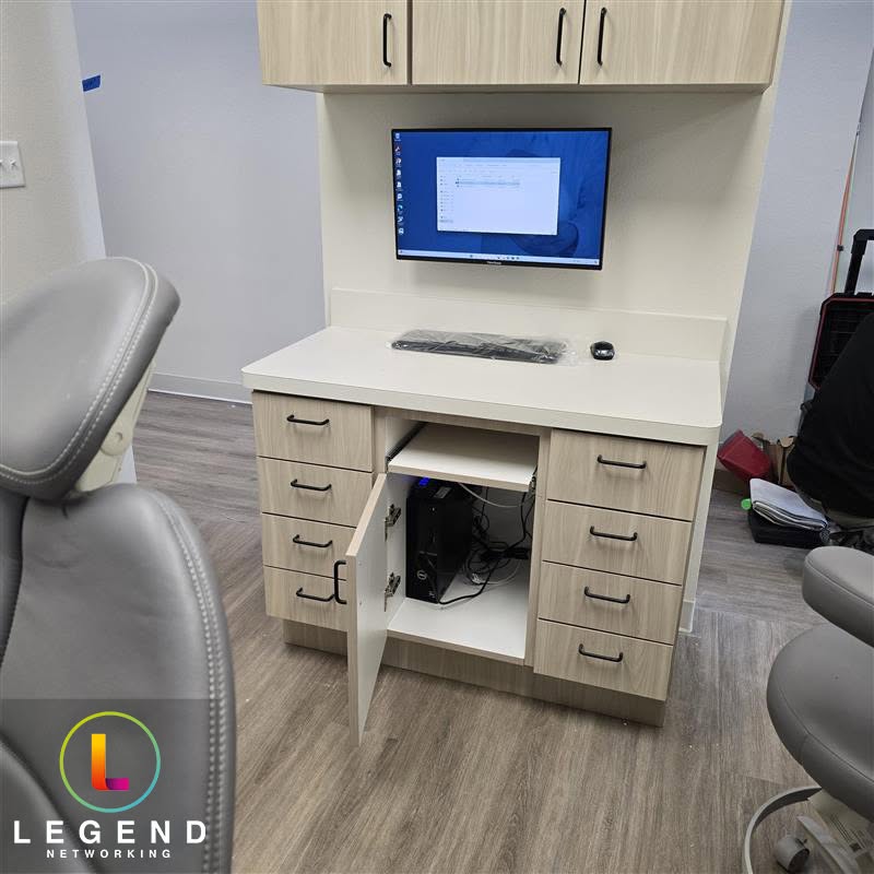 Clinical workstation and open equipment cabinet during the Everlasting Dentistry installation.