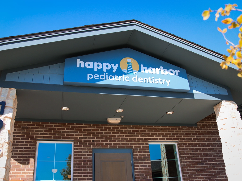Exterior entrance and Happy Harbor Pediatric Dentistry sign at the Rockwall, Texas practice.