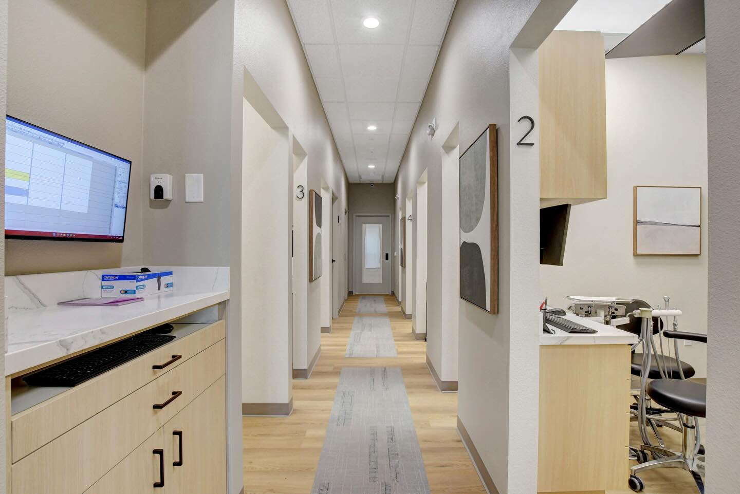 Finished Haven Dental hallway connecting numbered treatment rooms with built-in work surfaces.