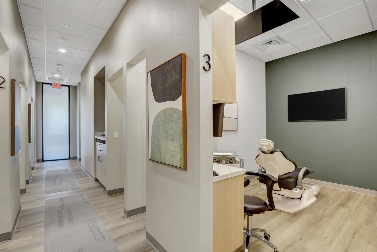 Finished Haven Dental treatment room with a patient chair, cabinetry and wall-mounted display.