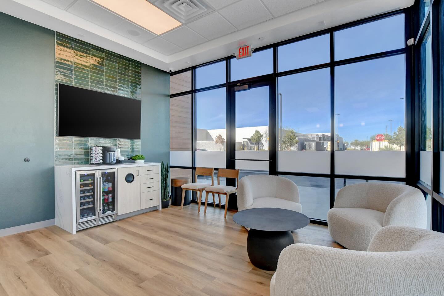 Finished Haven Dental waiting area with lounge seating, large windows and a refreshment counter.