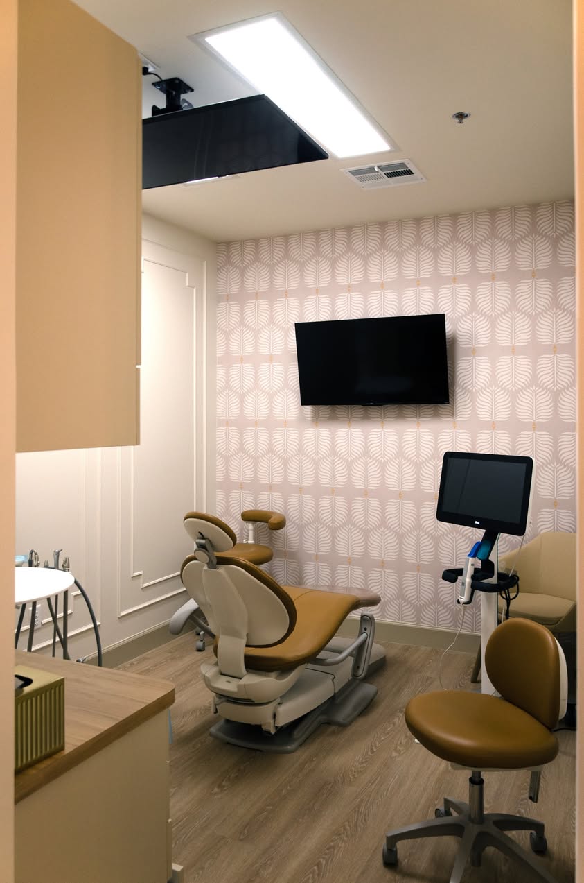 Dental chair and monitor inside a Prosper Star Dental Co. operatory.