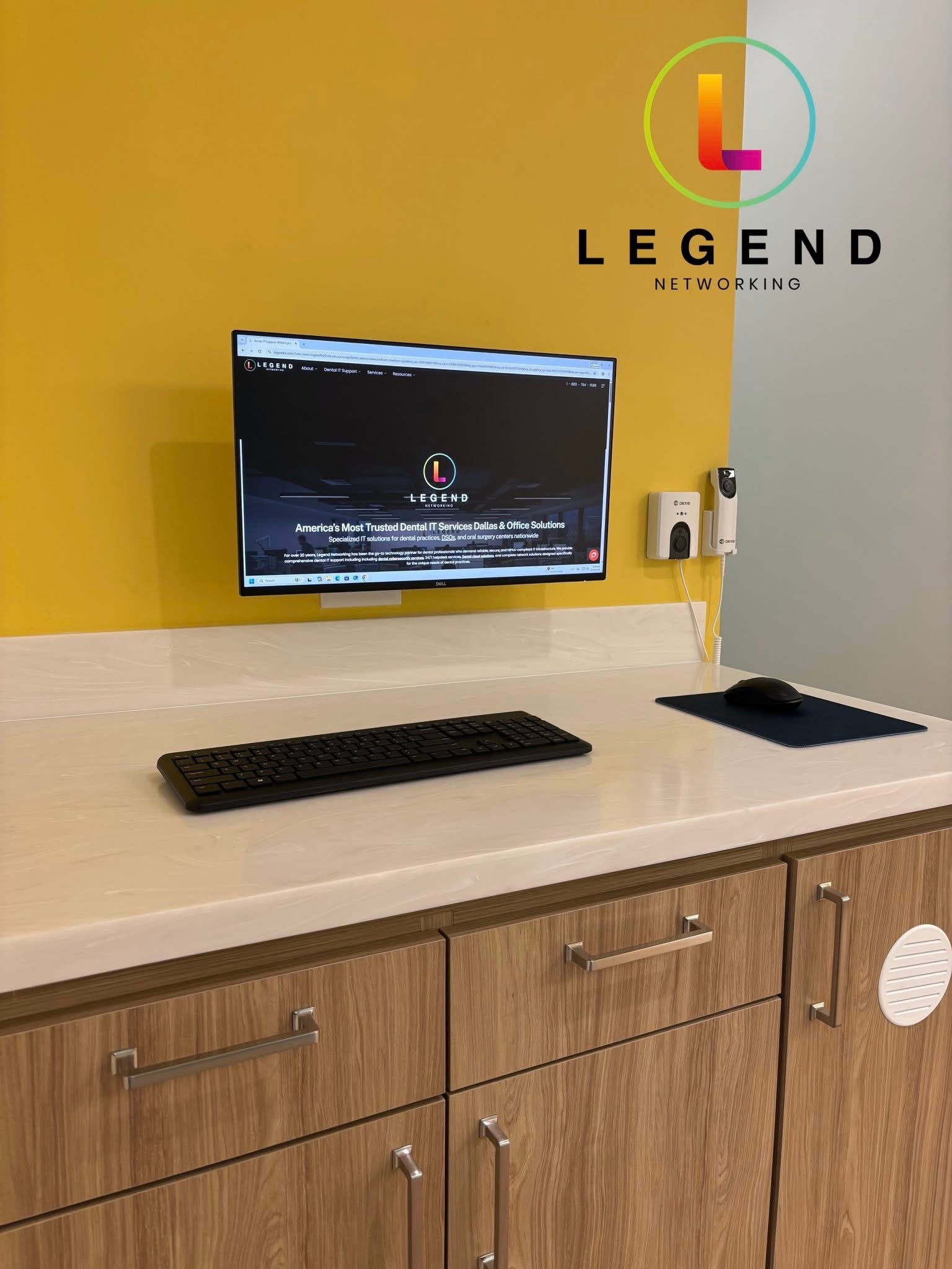 Ray Orthodontics operatory counter with wall-mounted monitor, keyboard and mouse.